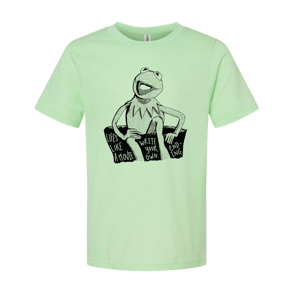 A light green t-shirt with a black and white illustration of Kermit the Frog sitting on a rock and the text "Lives like a movie, write your own" printed on it.
