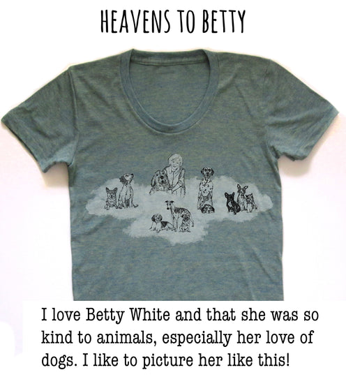 A gray t-shirt with a graphic design depicting a woman surrounded by various dogs. The text above the image reads "HEAVENS TO BETTY".