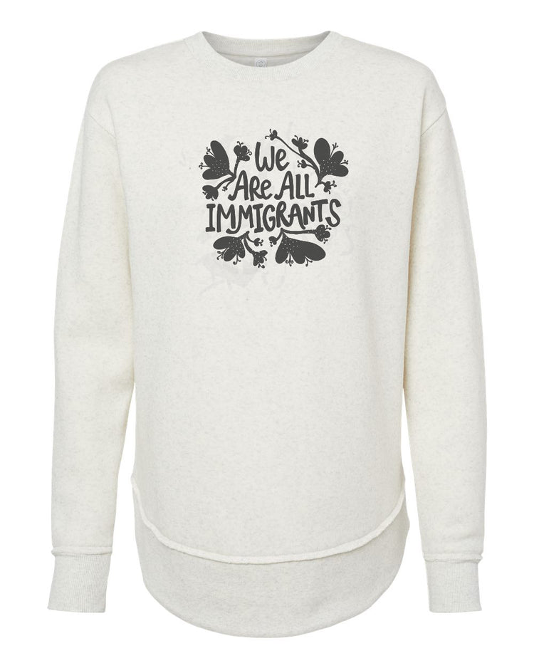 A white long-sleeved sweatshirt with a graphic design on the front that reads "We Are All Immigrants".
