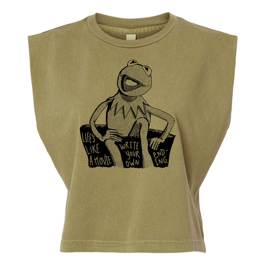 A t-shirt with a graphic design featuring a frog character and text that reads "Lives like a movie, write your own, ending -ing".