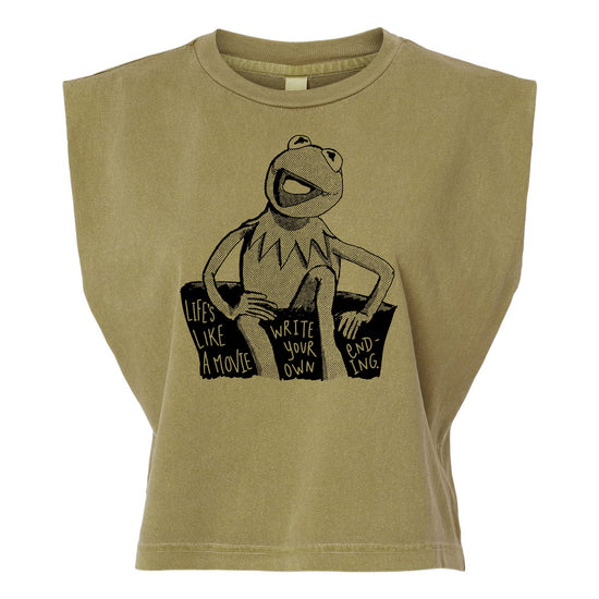 A t-shirt with a graphic design featuring a frog character and text that reads "Lives like a movie, write your own, ending -ing".