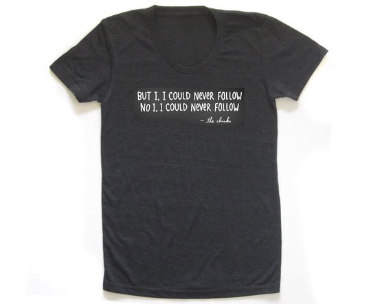 A black t-shirt with a white text message printed on it.