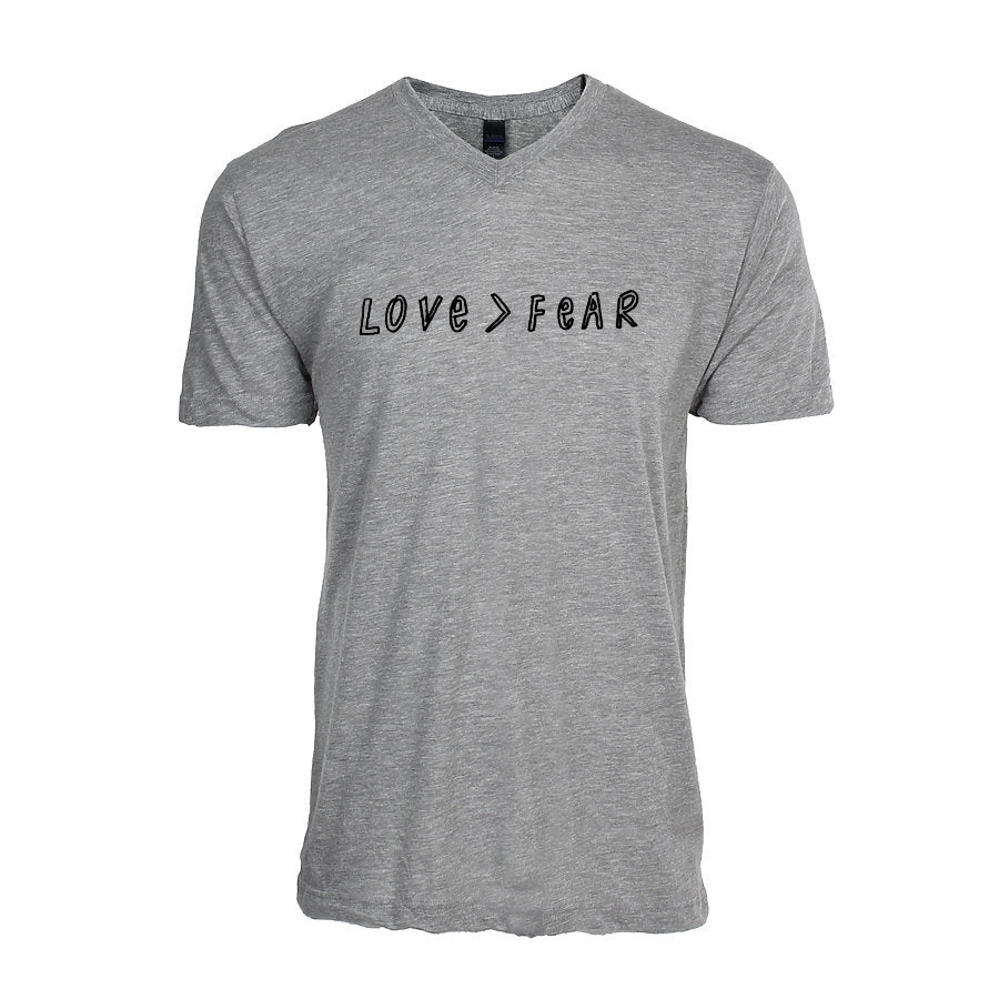 A gray t-shirt with the text "LOVE > FEAR" printed on it.