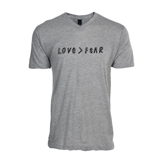 A gray t-shirt with the text "LOVE > FEAR" printed on it.