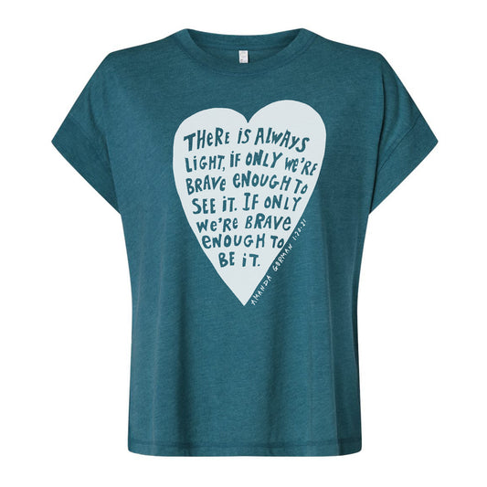 The image is a teal-colored t-shirt with a white heart-shaped graphic containing a motivational quote.