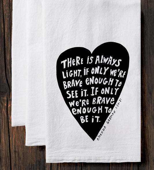 a white towel with a black heart-shaped design containing a motivational quote.