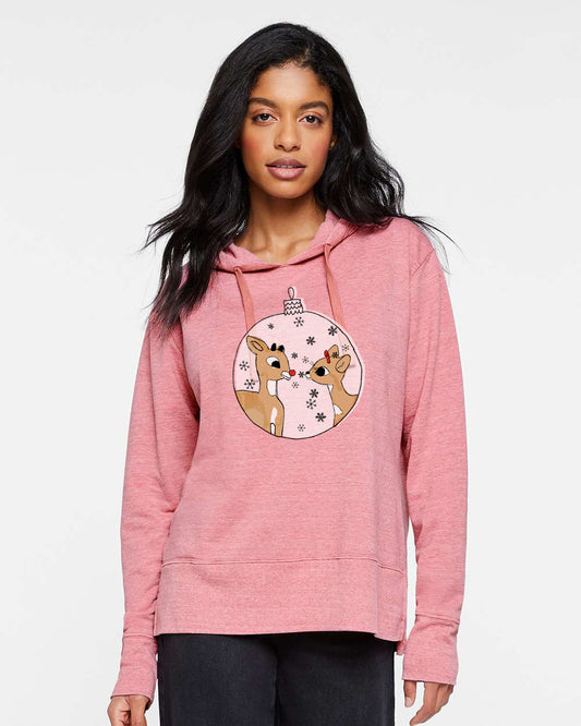 A woman wearing a pink hoodie with a graphic of two cartoon reindeer on it.