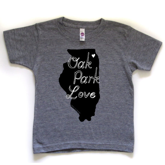 A gray t-shirt with a graphic design of the state of Illinois and the text "OAK PARK LOVE" printed on it.