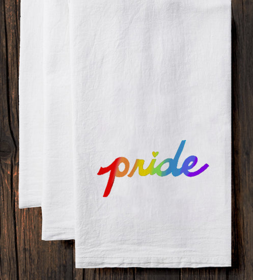 a white towel with the word "pride" printed on it in a rainbow color scheme.