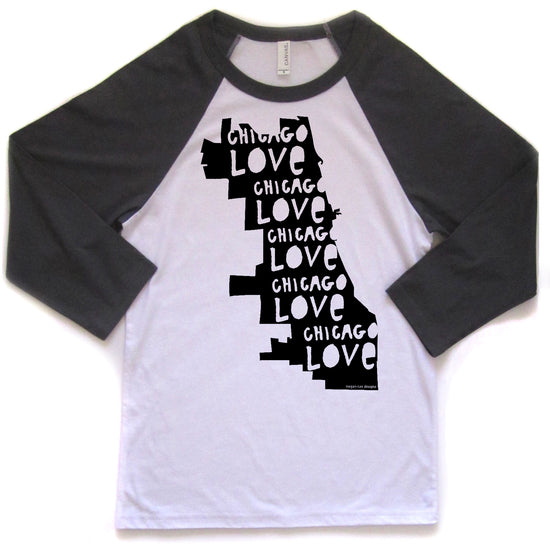A white and black baseball-style t-shirt with the text "CHICAGO LOVE CHICAGO LOVE CHICAGO LOVE" printed on it in a vertical orientation.
