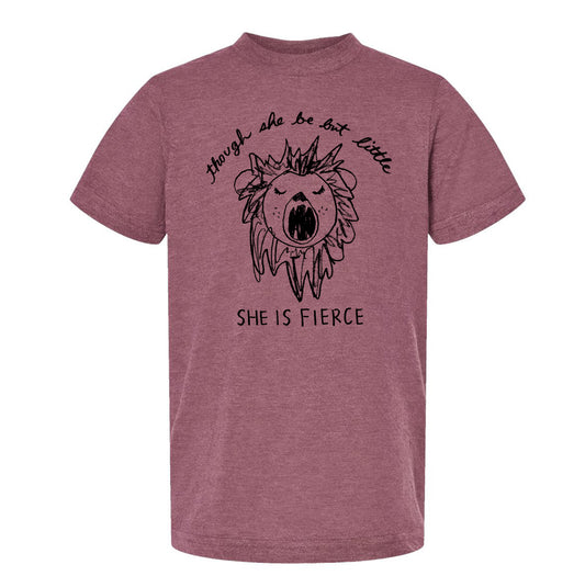 A maroon t-shirt with a graphic design depicting a lion's head and the text "SHE IS FERCENCE" printed on it.