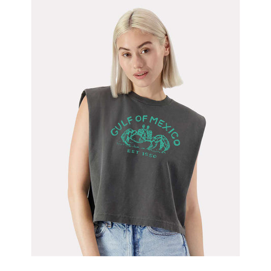 A young woman with blonde hair wearing a gray sleeveless t-shirt with a graphic design and text printed on it.