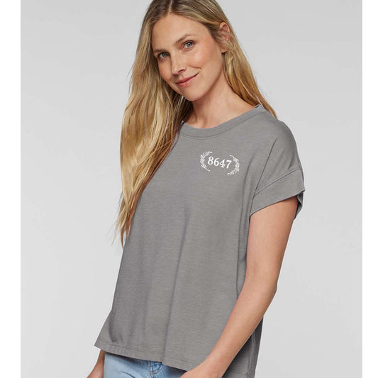 A young woman with long blonde hair is smiling and posing for the camera.