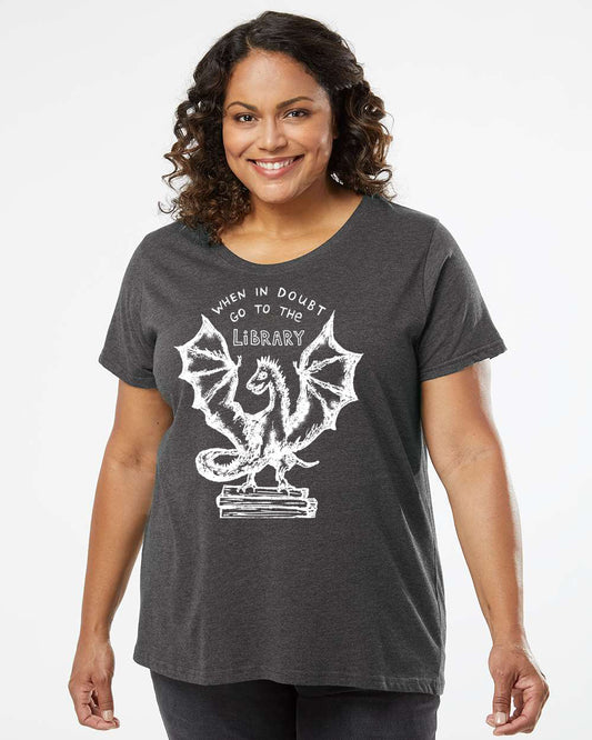 a woman wearing a dark t - shirt with a bat on it