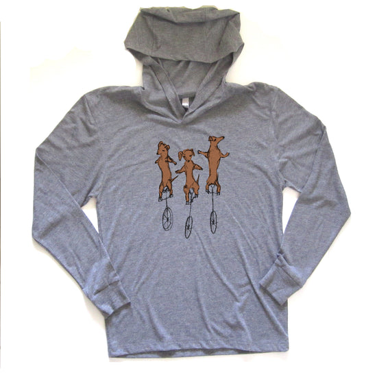 A gray hoodie with a graphic design of three cartoon dogs riding unicycles.