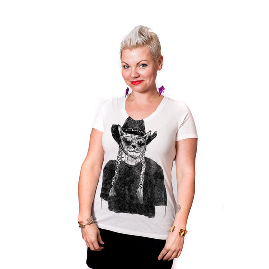 A woman wearing a white t-shirt with a graphic of a cat wearing a cowboy hat and sunglasses.