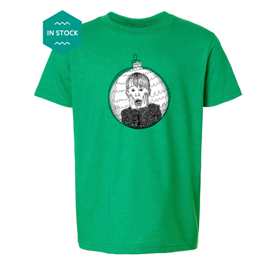 a green t - shirt with a picture of a boy in a christmas orname