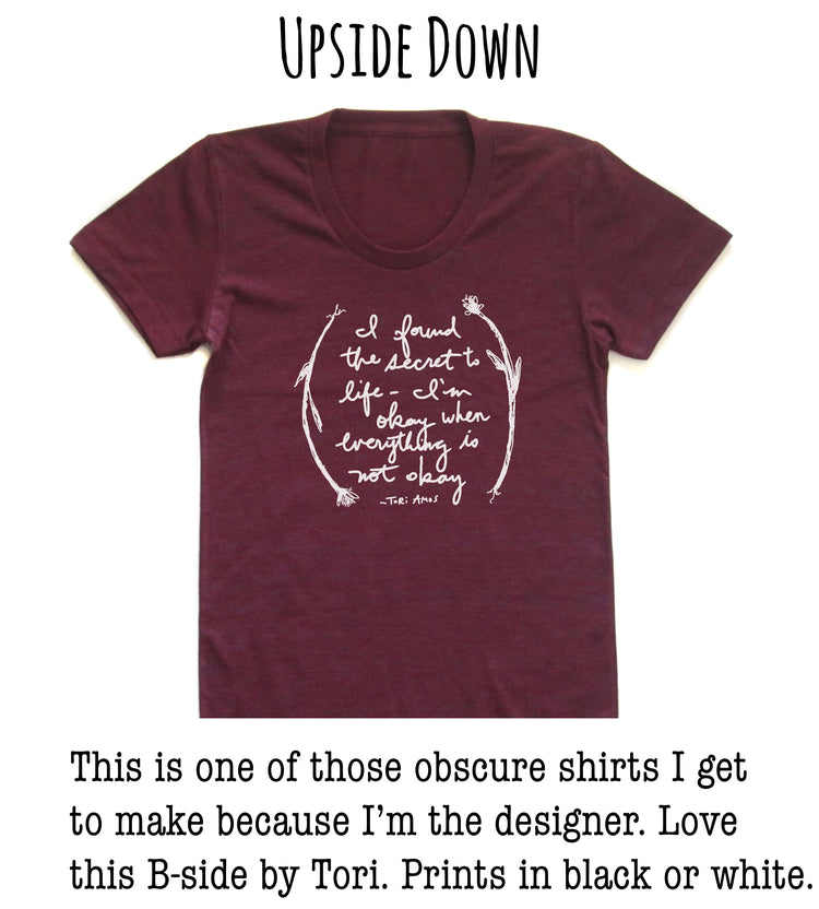 A burgundy-colored t-shirt with a white text quote printed on it, which reads "I found the secret to life & death whenering is notaries".