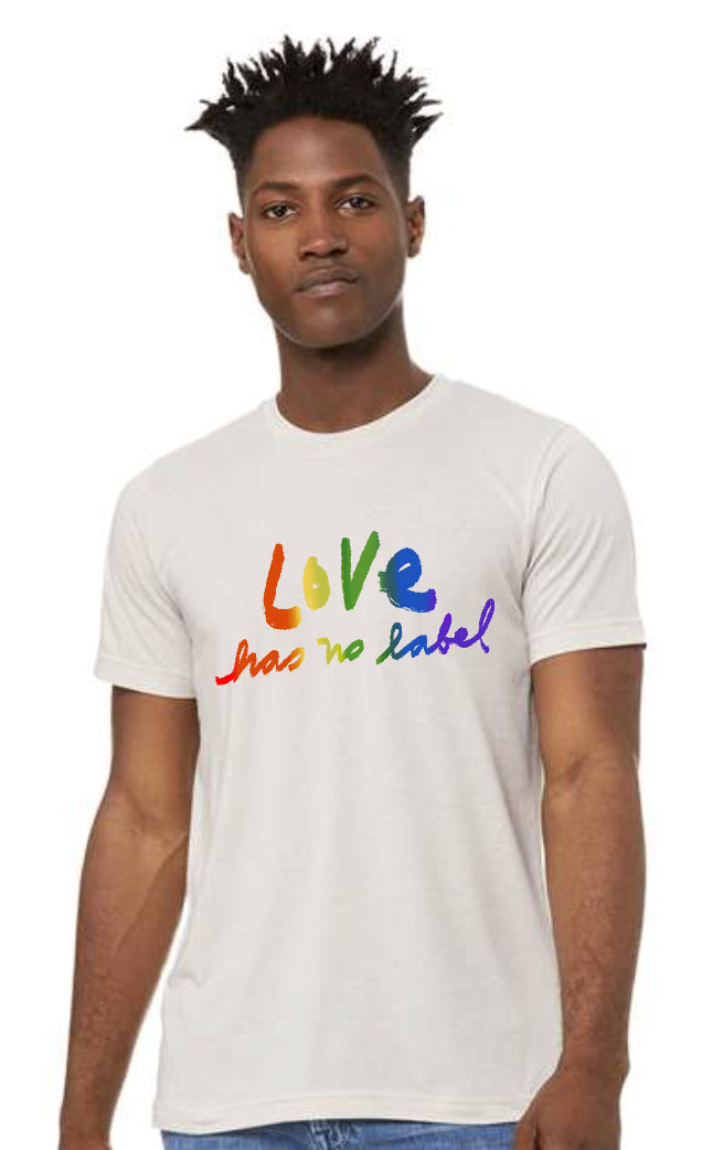A man wearing a white t-shirt with the text "Love has no label" printed on it.