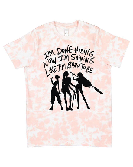 A t-shirt with a graphic design featuring silhouettes of three people and text that reads "I'm done hiding now I'm shining like I'm born to be".