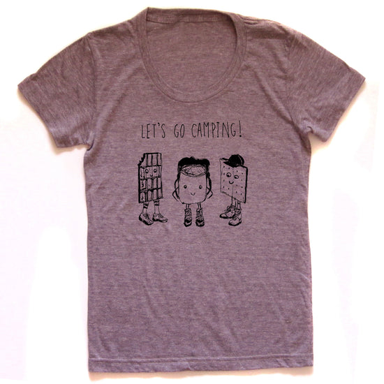 A gray t-shirt with a graphic design featuring three anthropomorphic objects, including a chocolate bar, a book, and a person, along with the text "LET'S GO CAMPING!"