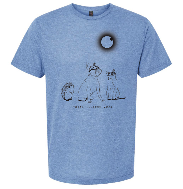 A blue t-shirt with a graphic design depicting a dog, hedgehog, and cat looking up at a black circle representing a total eclipse of the moon.
