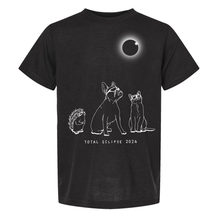 A black t-shirt with a graphic design depicting a total eclipse of the moon, featuring silhouettes of a dog, cat, and hedgehog.