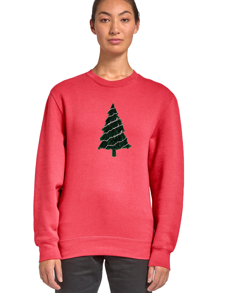 A woman wearing a red sweater with a Christmas tree design on it.