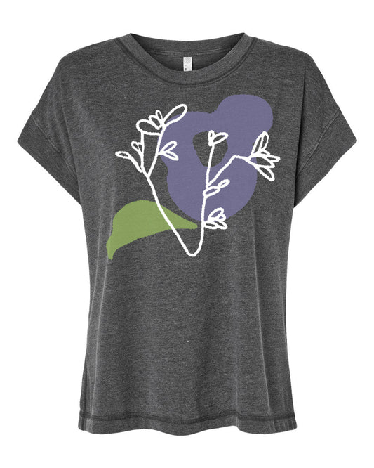 A gray t-shirt with a graphic design featuring a stylized purple flower and green leaves.