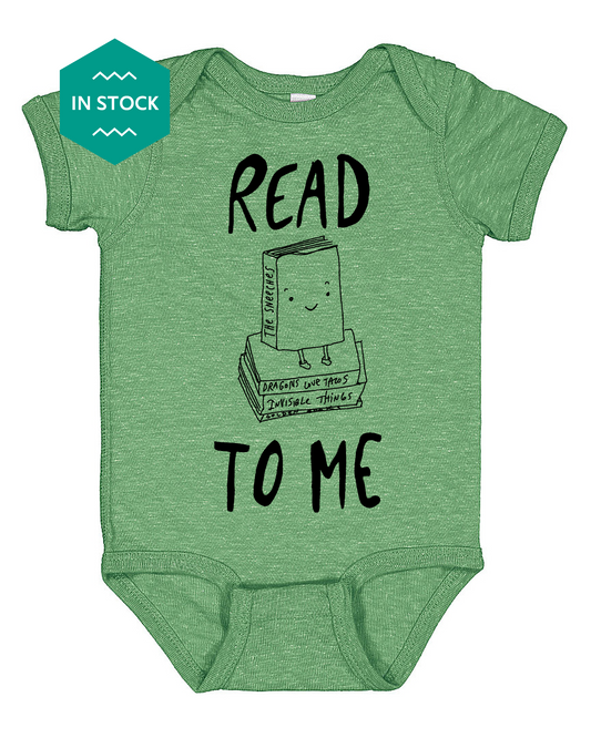 a green baby bodysuit with the words read to me printed on it
