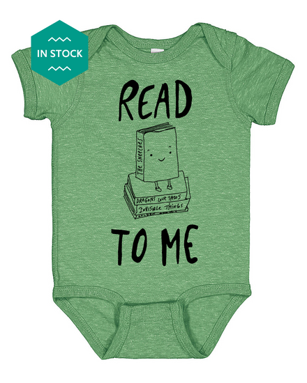a green baby bodysuit with the words read to me printed on it