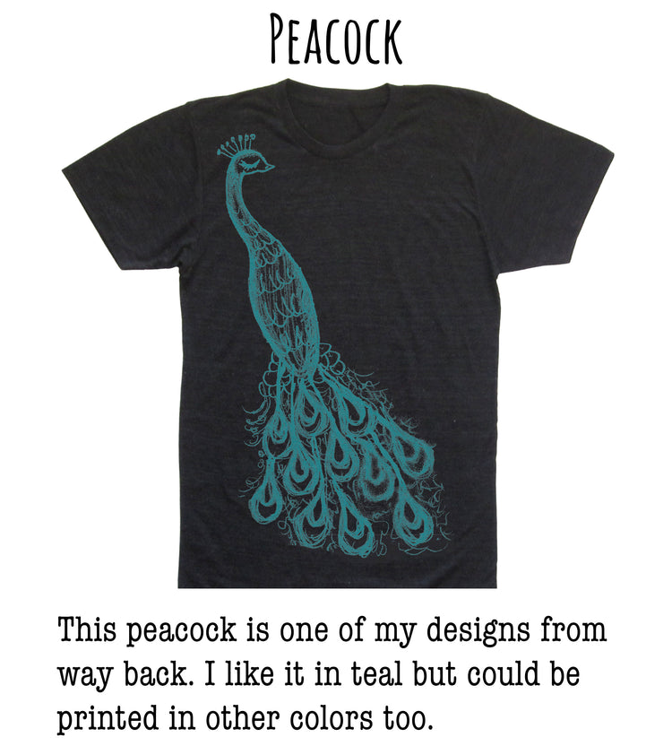 a black t-shirt with a teal design of a peacock, which is one of the designer's creations.