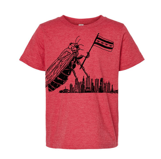 A red t-shirt with a graphic design depicting a large insect, possibly a bee or wasp, flying over a city skyline.