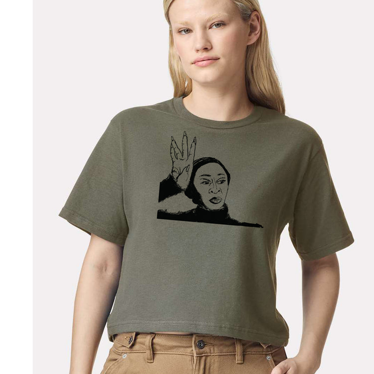 A woman wearing a green t-shirt with a graphic design of a person's face.