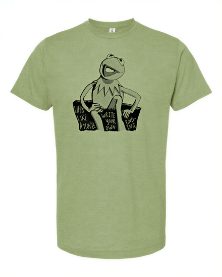 A green t-shirt with a black and white graphic of Kermit the Frog sitting on a couch and the text "Life like a movie" printed on it.