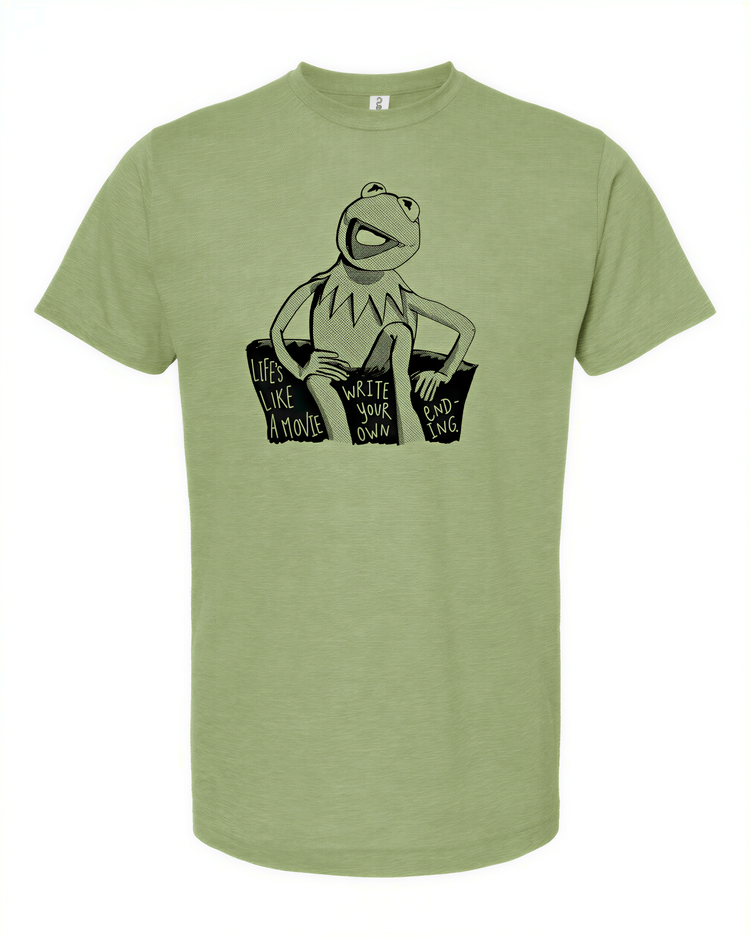 A green t-shirt with a black and white graphic of Kermit the Frog sitting on a couch and the text "Life like a movie" printed on it.