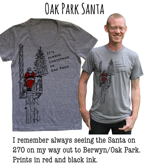 a gray t-shirt with a Santa Claus illustration and text, along with a man wearing a gray t-shirt with a similar Santa Claus illustration and text. The text on the t-shirts reads "It's always seeing the Santa on 270 on my way out to Berwyn/Oak Park. Prints in red and black ink."