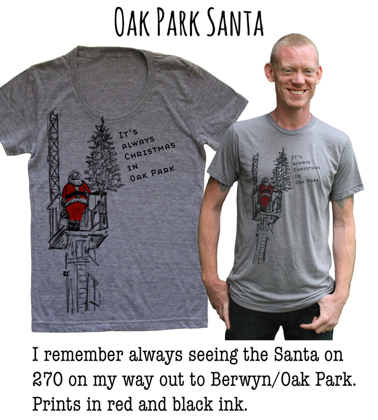 a gray t-shirt with a Santa Claus illustration and text, along with a man wearing a gray t-shirt with a similar Santa Claus illustration and text. The text on the t-shirts reads "It's always seeing the Santa on 270 on my way out to Berwyn/Oak Park. Prints in red and black ink."