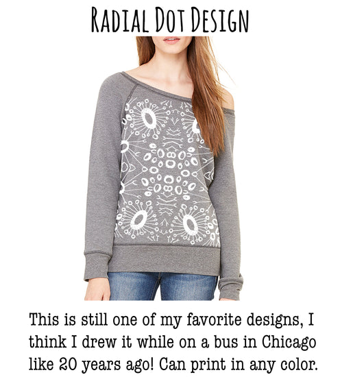a woman wearing a gray sweater with a floral pattern.