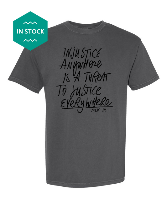 a grey t - shirt with black writing on it