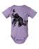 A purple baby onesie with a black graphic design depicting an owl and the text "You may dream, but I am only one" printed on it.