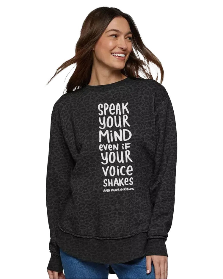 A woman wearing a black sweatshirt with white text on it.