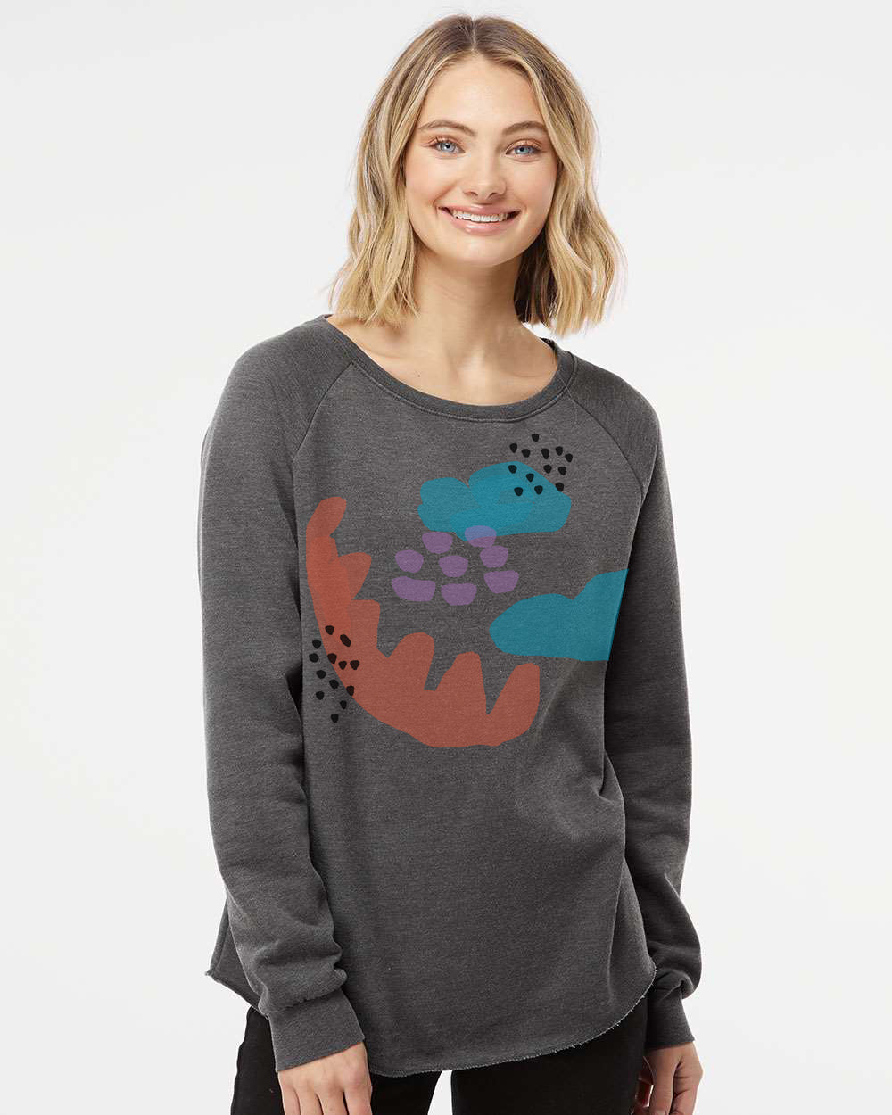 a woman wearing a grey sweater with colorful flowers on it