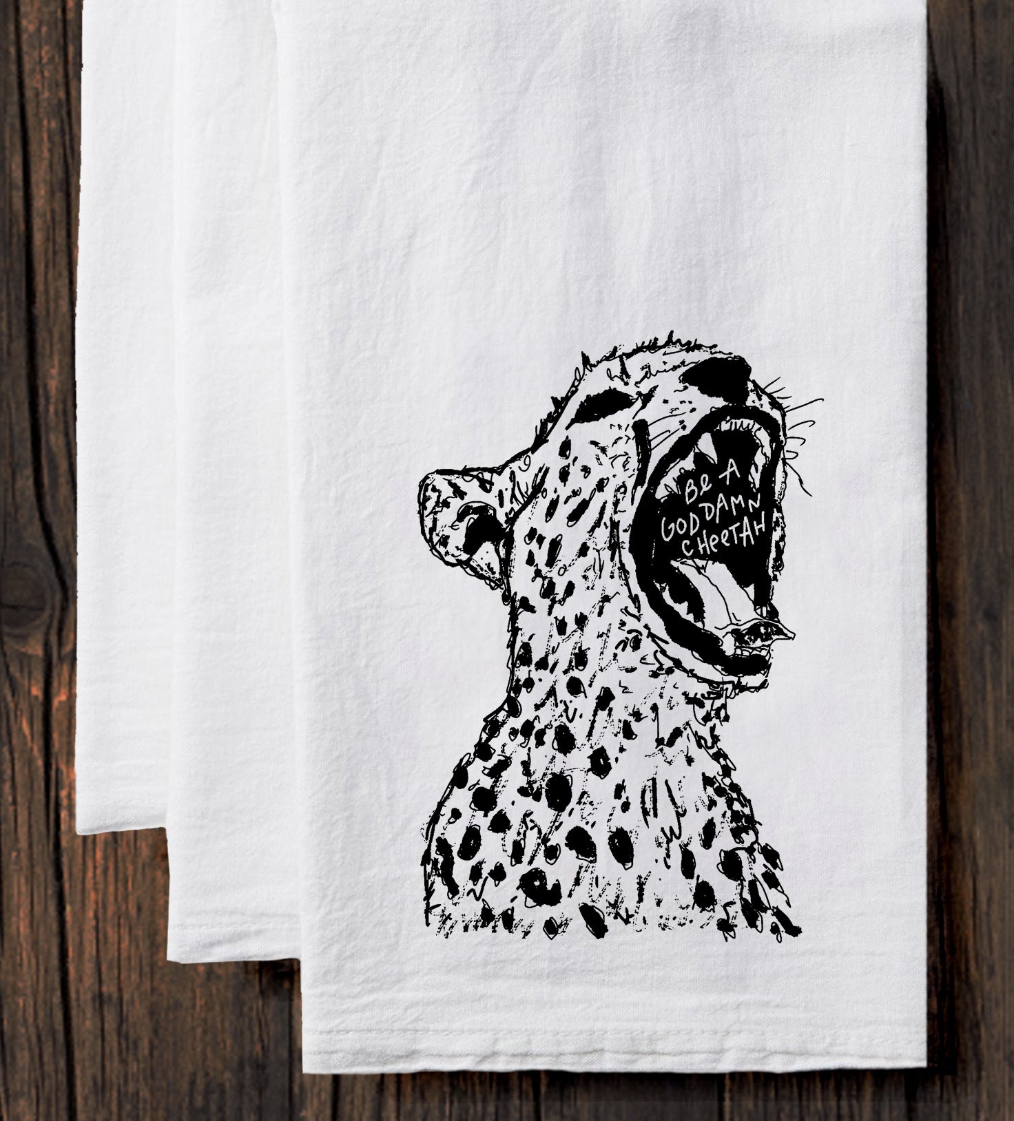 a white towel with a black and white drawing of a cheetah